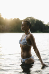 Woman wearing a bikini in a lake at sunset - KNSF05187