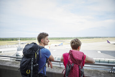 Rear view of couple on observation deck at the airport - RHF02241
