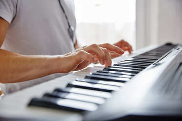 Hands of man playing digital piano - RHF02269