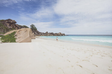 Seychellen, La Digue, Grand Anse, Frau beim Spaziergang am Strand - MMAF00686