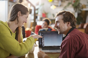 Couple using laptop at table - HOXF04104