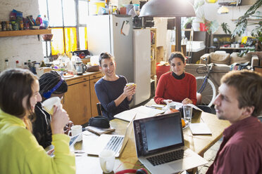 Young college student friends studying at kitchen table in apartment - HOXF04106