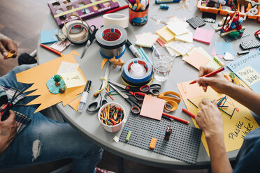 High angle view of colleagues working at table in creative office - MASF09355