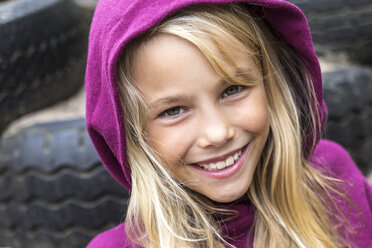 Porträt eines lächelnden blonden Mädchens mit rosa Kapuzenjacke - JFEF00912