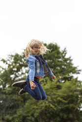 Portrait of blond girl jumping in the air - JFEF00913