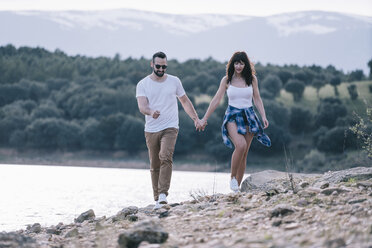 Couple in love walking hand in hand in nature - OCMF00039