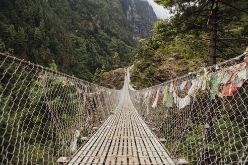 Diminishing perspective of footbridge amidst mountains at Sagarmatha National Park - CAVF52371