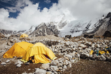 Tents on mountain against cloudy sky during sunny day - CAVF52380