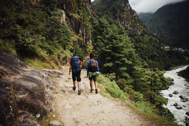 Rear view of friends with backpacks hiking at Sagarmatha National Park - CAVF52390