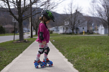 Side view of girl roller skating on footpath at park - CAVF52562