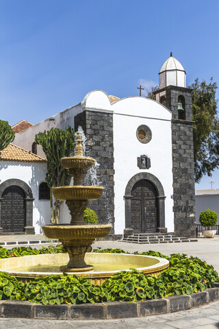 Spain, Canary Islands, Lanzarote, San Bartolome, view to Parish church with fountain in the foreground stock photo