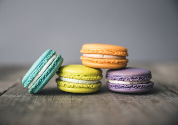 Close-up of colorful macaroons on wooden table - CAVF52634