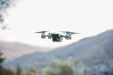 Close-up of quadcopter flying against clear sky - CAVF52654