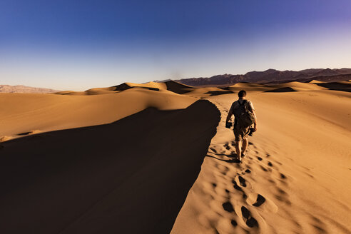 USA, Kalifornien, Death Valley, Death Valley National Park, Mesquite Flat Sand Dunes, Mann läuft auf Düne - FCF01520