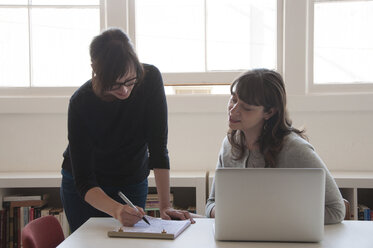 Businesswomen working together in new office - CAVF52787