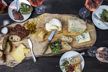 High angle view of various food with wine served on wooden table - CAVF52914