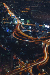 Aerial view of light trails on road amidst city at night - CAVF52924