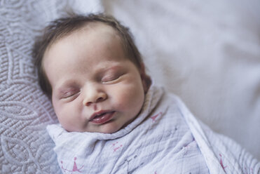 Close-up of cute baby girl sleeping on bed at home - CAVF53110