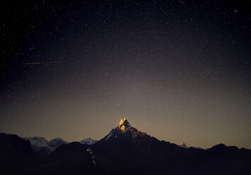 Scenic view of Machapuchare Mountains against star field at night - CAVF53160