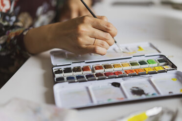 Illustrator painting at work desk in an atelier, close-up - AFVF01917