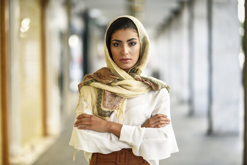 Spain, Granada, young muslim tourist woman wearing hijab in urban city background - JSMF00548