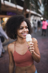 USA, Nevada, Las Vegas, happy young woman eating ice cream in the city - KKAF02905