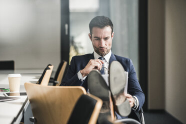 Businessman reading documents during his coffee braek - UUF15776