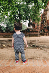 Thailand, Ayutthaya, Baby girl exploring Wat Mahathat temple - GEMF02483