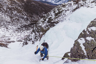 Hochformatige Ansicht eines Wanderers beim Eisklettern in den White Mountains im Winter - CAVF53542
