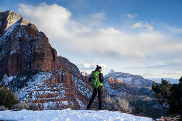 Woman with Backpack Sliding Down on Snow Covered Hiking Trail with  Panoramic View on Snowcapped Mountain Peak Kreiskogel Stock Photo - Image  of recreation, backpacker: 265315204