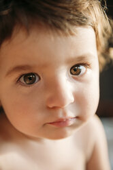 Close-up portrait of cute shirtless baby girl at home - CAVF53643