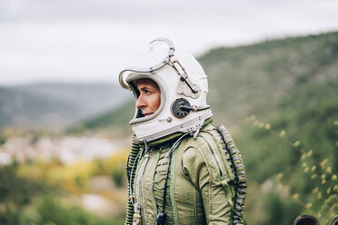 Woman in space suit exploring nature - OCMF00085