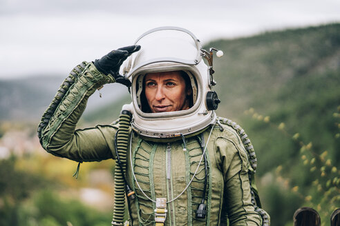 Portrait of woman in space suit exploring nature - OCMF00086