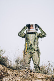 Woman in space suit exploring nature - OCMF00090