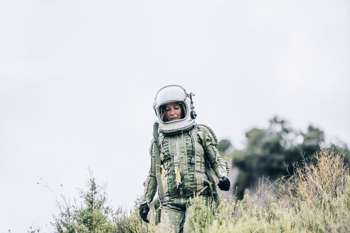 Woman in space suit exploring nature - OCMF00091
