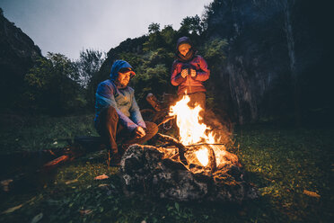 Couple with with bikes at camp fire - OCMF00093