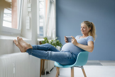 Future Mother. Jovial Pregnant Woman Resting In Chair And Smiling