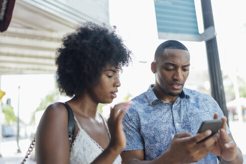 USA, Florida, Miami Beach, young couple using cell phone in the city - BOYF00838