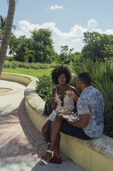 USA, Florida, Miami Beach, junges Paar, das sich einen Salat in einem Park teilt - BOYF00850