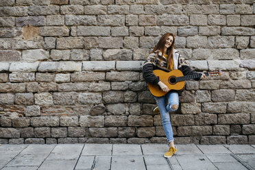 Red-haired woman playing the guitar in the city - JRFF01933