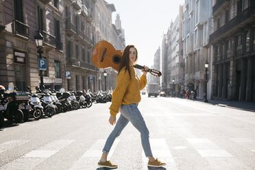 Red-haired woman with a guitar on zebra crossing - JRFF01938