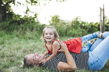 Portrait of happy girl with mother on meadow - HMEF00060