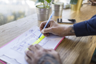 Close-up of architect working on construction plan - VGF00096