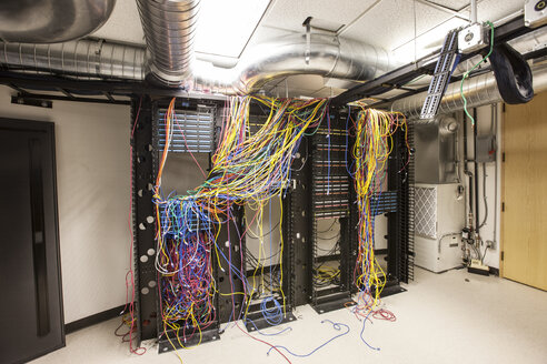 A mess of Cat 5 cables in an office server room. - MINF09538