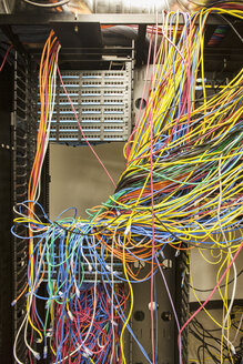 A mess of Cat 5 cables in an office server room. - MINF09539