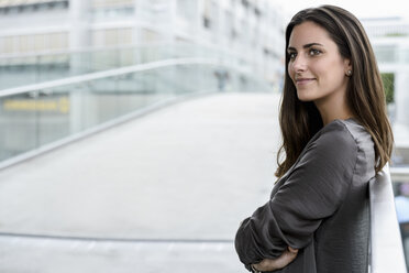 Portrait of smiling young businesswoman looking at distance - BMOF00072