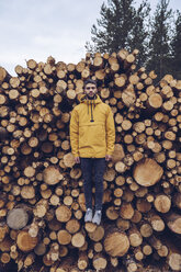 Young man standing on a stck of wood, giving the illusion of hovering - RSGF00125