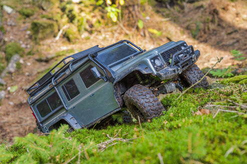 Germany, remote control car driving on moss - FRF00755