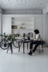 Mid adult woman working in her home office, using laptop - BOYF00891