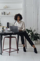 Mid adult woman working in her home office, using laptop - BOYF00894